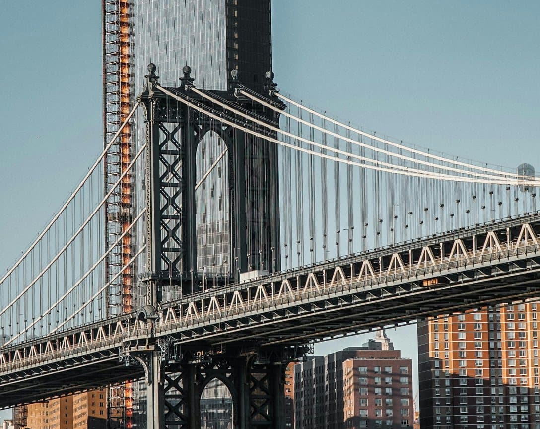 The Manhattan Bridge tower and cables above the Brooklyn waterfront